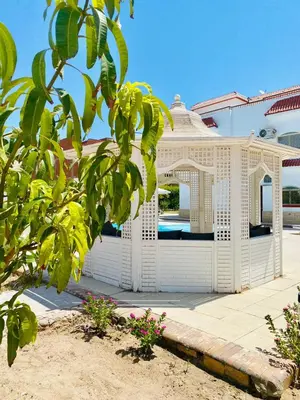 a white gazebo in front of a house at Hurghada- Magawish Studio 3 in Hurghada