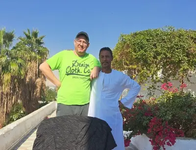 two men standing next to each other on a porch at Gabawy Garden Doppelzimmer in Luxor