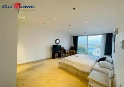 a bedroom with a bed and a large window at Pretty 4BR Penthouse MB7 with Private Heated Pool at New Marina in Hurghada