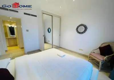 a room with a large bed and a chair in it at Pretty 4BR Penthouse MB7 with Private Heated Pool at New Marina in Hurghada