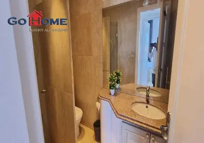 a bathroom with a sink and a toilet at Pretty 4BR Penthouse MB7 with Private Heated Pool at New Marina in Hurghada