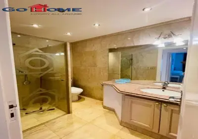a bathroom with a shower and a sink and a toilet at Pretty 4BR Penthouse MB7 with Private Heated Pool at New Marina in Hurghada