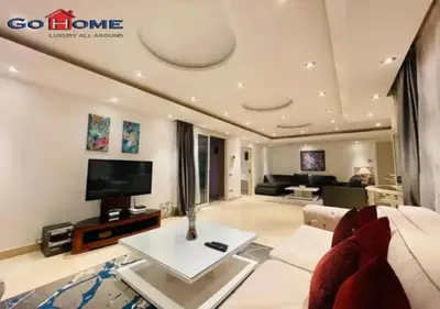 a living room with a couch and a tv at Pretty 4BR Penthouse MB7 with Private Heated Pool at New Marina in Hurghada