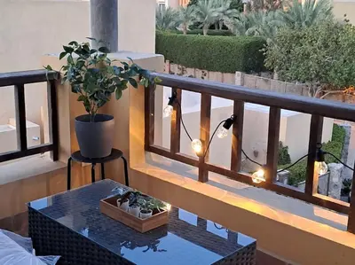 a balcony with a table and a potted plant at Luxury in the heart of Gouna in Hurghada