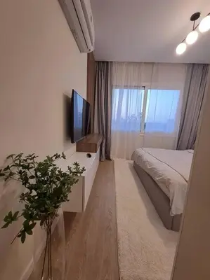 a bedroom with a bed and a television on a desk at Luxury in the heart of Gouna in Hurghada