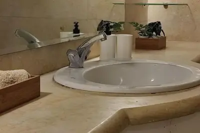 a bathroom sink with a faucet and a mirror at Luxury in the heart of Gouna in Hurghada