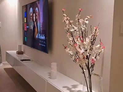 a living room with a tv and a vase with flowers at Luxury in the heart of Gouna in Hurghada
