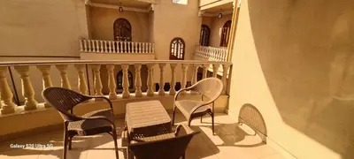a balcony with chairs and a table and a railing at Moon fourteen2 in Luxor