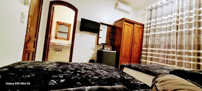 a bedroom with a bed and a window and a television at Moon fourteen2 in Luxor