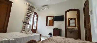 a room with a bed and a sink and a mirror at Moon fourteen2 in Luxor