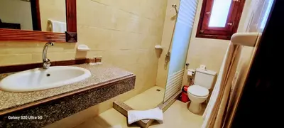 a bathroom with a sink and a toilet at Moon fourteen2 in Luxor
