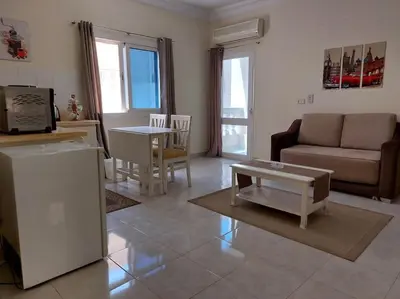 a living room with a couch and a table at Cozy/Comfy Studio at Intercontinental Area in Hurghada