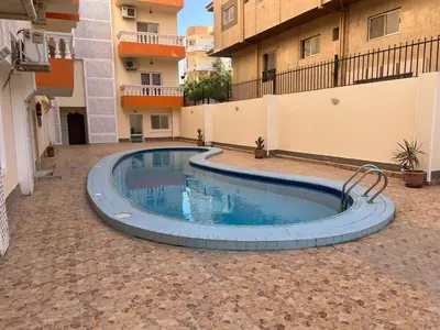 a swimming pool in the middle of a courtyard at Cozy/Comfy Studio at Intercontinental Area in Hurghada