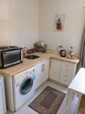 a kitchen with a sink and a washing machine at Cozy/Comfy Studio at Intercontinental Area in Hurghada