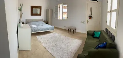 a living room with a couch and a bed at CozY Condo in Hurghada