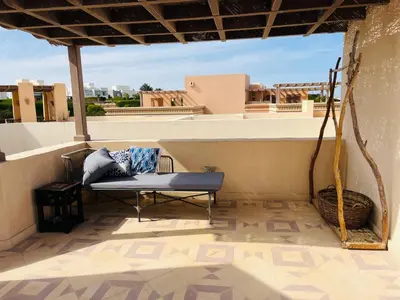 a bench sitting on top of a balcony at CozY Condo in Hurghada