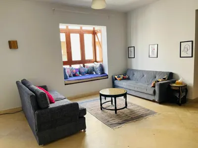 a living room with a couch and a chair and a table at CozY Condo in Hurghada