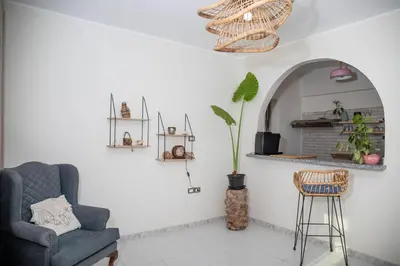 a living room with a chair and a mirror at Villa Anna & Snake in Hurghada