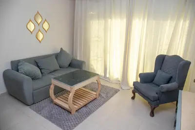 a living room with a couch and a chair and a table at Villa Anna & Snake in Hurghada