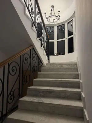 a staircase in a house with a chandelier at Villa Anna & Snake in Hurghada