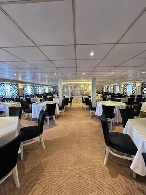 a dining room on a cruise ship with tables and chairs at Luxor Aswan Coral 2 Nile Cruise every Saturday from Luxor 4 nights & every Wednesday from Aswan 3 nights in Luxor