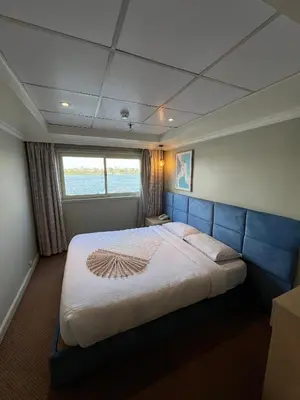 a bedroom with a large bed in a boat at Luxor Aswan Coral 2 Nile Cruise every Saturday from Luxor 4 nights & every Wednesday from Aswan 3 nights in Luxor