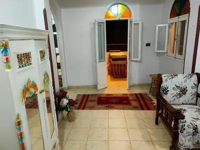 a hallway with a living room with a couch and a window at Top View in Luxor