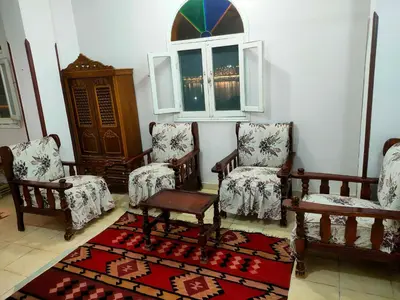 a room with chairs and a table and a window at Top View in Luxor