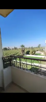 a balcony with a view of a golf course at Top View in Luxor