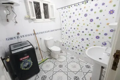 a small bathroom with a toilet and a sink at Top View in Luxor