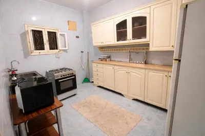a kitchen with white cabinets and a stove at Top View in Luxor