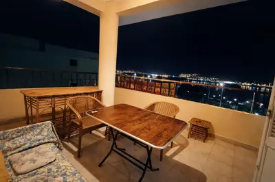a balcony with a table and chairs and a view of the city at Top View in Luxor